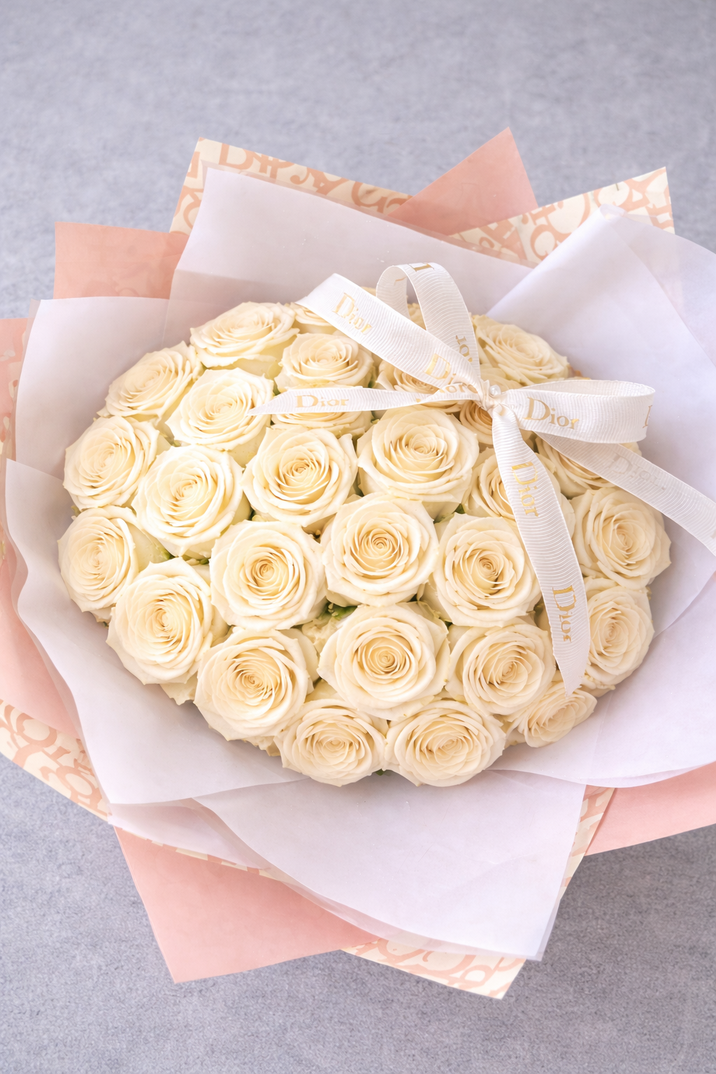 24 white rose bouquet in designer inspired nude wrapping