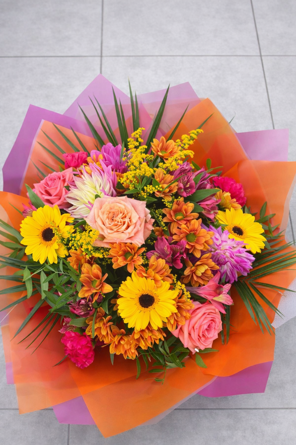 Colorful bouquet of flowers on a tiled floor