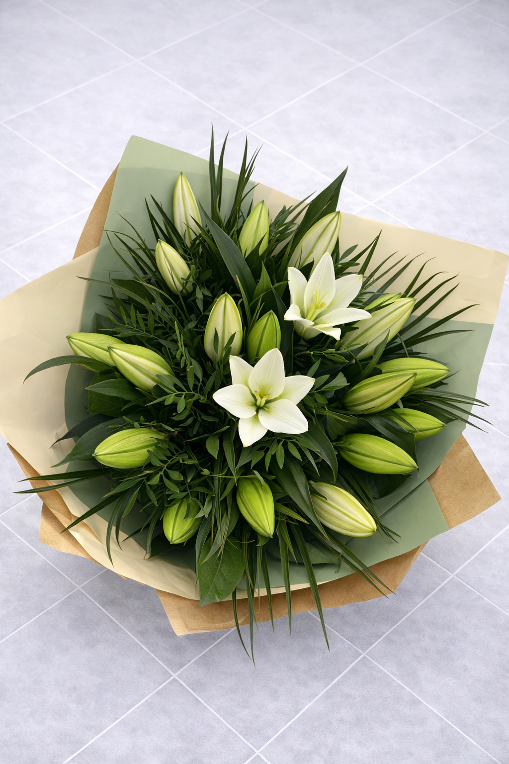 Bouquet of white lilies and greenery on a light grey background